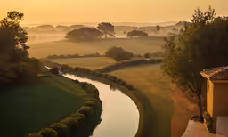 the view of a river surrounded by grass and trees