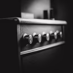 black and white photograph of the back panel of a stove