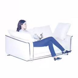 the young woman is sitting on a couch with her laptop