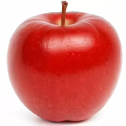 a very big shiny red apple that looks like a heart