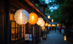 a street that has paper lanterns strung from it