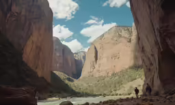 two people are looking over the canyon wall