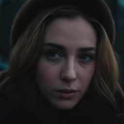 the girl with blue eyes is looking towards the camera