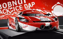a red and white car that is on display,the front of a race car on display
