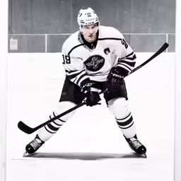 black and white photograph of a hockey player on ice