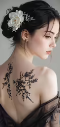 a young woman has a flower pinned to her back
