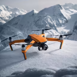 an orange remote control quadcopter in the snow