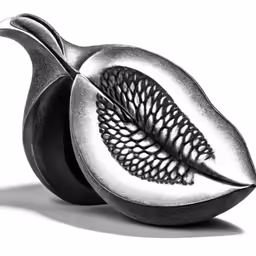 the two pieces of an artistic fruit have a piece shaped like a leaf