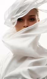 woman in white covering herself with shawl