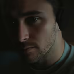 a man with headphones is looking into the distance