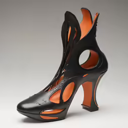 a pair of black shoes with cut out upper part and ankle straps