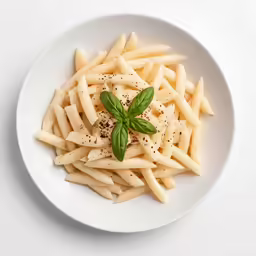 a plate full of penna, cheese, and herbs