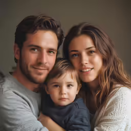 a young family poses with their young son