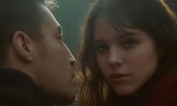 two people standing together and staring at each other