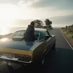 a man driving an old car along the road