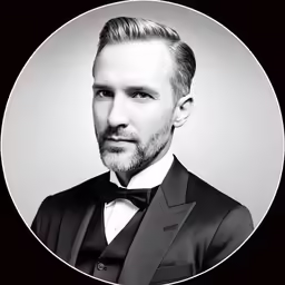 black and white photo of man wearing suit and bow tie