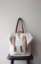 white bag hanging up on a wall
