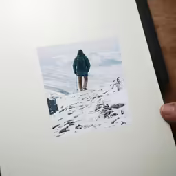 a person standing on top of a snow covered mountain