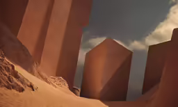 a large sculpture of rocks near some desert terrain
