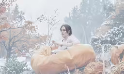 a woman sitting on top of a bean bag in the snow