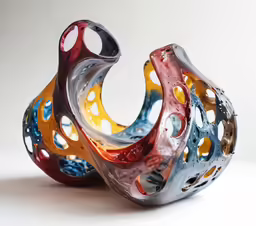 two colorful vases sitting next to each other