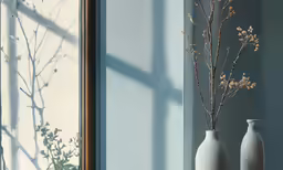 some very pretty vases by the window near the tree