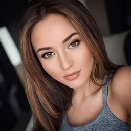 a very cute lady with big eyes looking at the camera