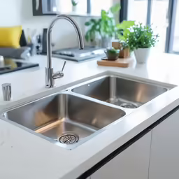 there is a silver sink and an island with granite counter tops