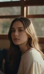 the beautiful young woman looks at the camera