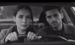 a man and a woman driving a car
