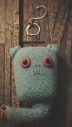 a grey stuffed animal on a wooden surface