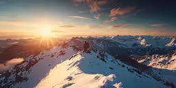 a person on the top of a mountain, with the sun going down
