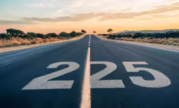 a empty highway with white numbers that are the center of the image