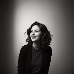 a woman posing for a black and white photograph