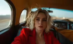 a woman wearing a red jacket and black shirt