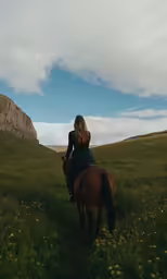 the girl is riding a horse in a grassy field