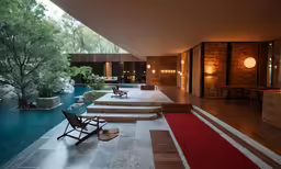 a long room with a pool and several lounge chairs