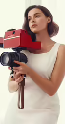 a young woman holding a red camera and pointing to the side