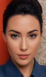 an attractive woman wearing a blue shirt and a dark hair