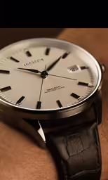 there is a silver and black watch on the arm