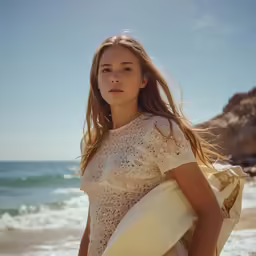 a girl is standing on the beach with a surfboard