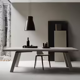 a modern dining table in white with a black lamp