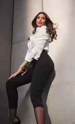 a beautiful woman with long legs and heels posing for the camera