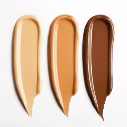 four different shades of lip glosses against white background