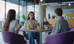 some people are having breakfast at a cafe