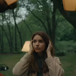 young woman listening to music while standing outdoors