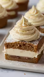 some cupcakes with cream filling on the top