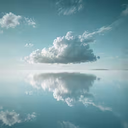 a large cloud floating in the sky over water