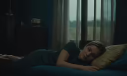 a woman with her head on her pillows