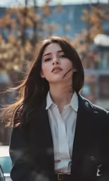 the girl with very long dark hair is looking at the camera